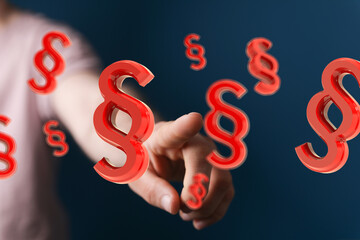 Abstract image of a hand interacting with red paragraph symbols.  Concept for law, legal, or...