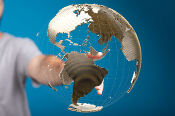 Person interacts with a digital globe, symbolizing global reach and connectivity.