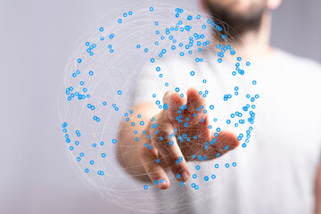 Abstract image of a hand interacting with a digital global network. Represents connection,...