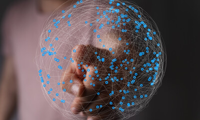Abstract image of a hand interacting with a digital sphere representing global network connections.