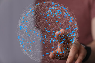 Abstract image of a hand interacting with a digital sphere representing global network connections.