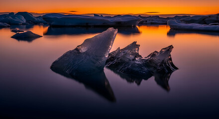Golden Hour At Glacier Lagoon With Icebergs Reflected On Waters