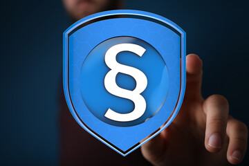 Hand interacts with a digital shield graphic, symbolizing secure legal protection and online safety.
