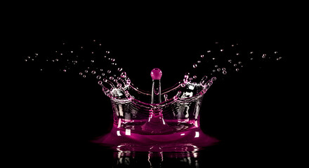 Majestic Purple Water Crown Splash Against a Dark Dramatic Backdrop