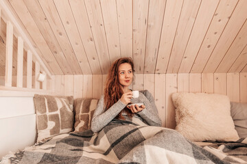 Happy Woman Drinking Morning Coffee in Bed