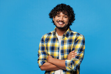 Young smiling happy cheerful happy Indian man wear yellow checkered shirt casual clothes hold hands...