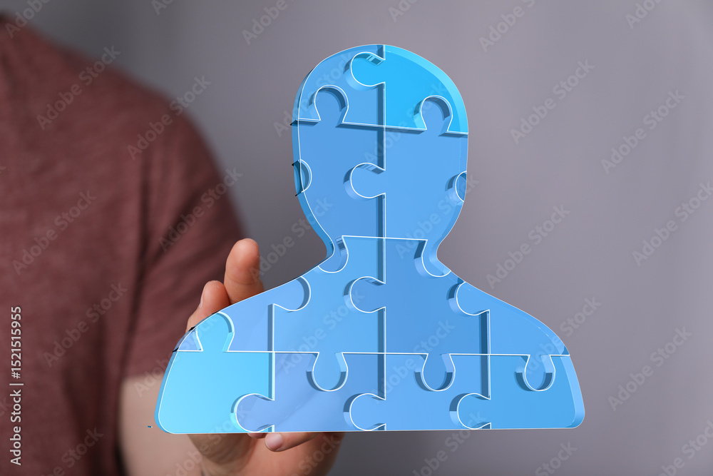 Aufkleber Abstract image of a person icon made of puzzle pieces, symbolizing teamwork, collaboration, and unity.
