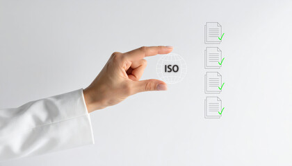 Businesswoman hand pinching virtual ISO icon, with document checklist and green check marks, symbolizing quality assurance and certification process