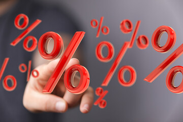 Hand interacting with 3D percentage symbols.  Perfect for finance, banking, investment, and...