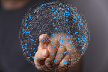 Hand interacts with a digital globe, showing network connections and data points.