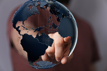 High-quality stock photo of a hand interacting with a 3D model of the Earth, symbolizing global...
