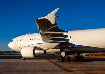 Midnight Freight: Cargo Jet Poised for Departure on Rain-Soaked Runway