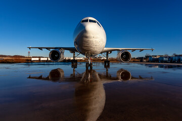 Midnight Freight: Cargo Jet Poised for Departure on Rain-Soaked Runway