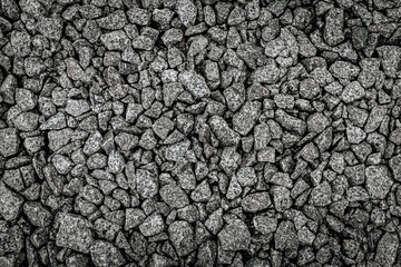 High-resolution top view of compacted crushed gravel stones in various sizes and shades of grey, showing detailed rocky texture and natural pattern.