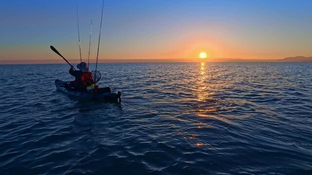 Kayak fishing angler in Mediterranean Sea sunrise