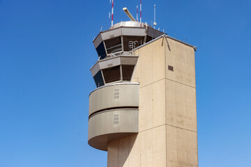 A contemporary design airport control tower on a sunny day with a clear sky,