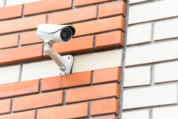 Security Camera on Brick Wall for Surveillance.