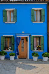Blue house with green shutters. Burano island, Venice