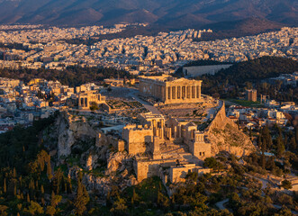 Aerial view of the Acropolis of Athens, Greece, with Parthenon Temple and Temple of the Athena Nike during golden sunset time