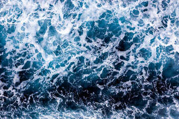 Ocean water texture. Top view of awesome water with foam. Can be used in covers, packaging, posters, textures, presentations, art and design projects. Stylish nature background image.
