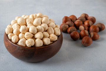 Heap of peeled and shelled hazelnuts on concrete background,closeup