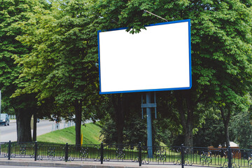 Blank Billboard in Urban Park with Green Trees