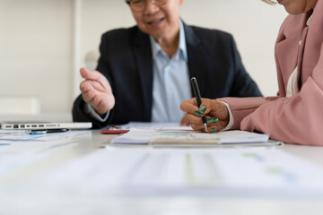 Senior businessmen analyzing data together.