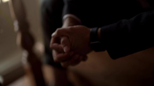 A close-up of hands elegantly adjusting cuff links while seated in a refined atmosphere. A watch on a man's hand that tells what time it is.