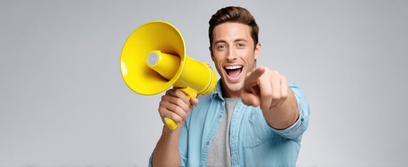 The enthusiastic young man using a yellow megaphone to engage an audience.