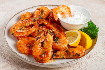 fried white-footed shrimp, tiger prawns vannamey, on a plate, with lemon and herbs, no people,