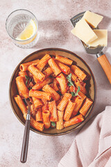 Rigatoni pasta with meat sauce and parmesan cheese on a light table, top view, homemade, no people,