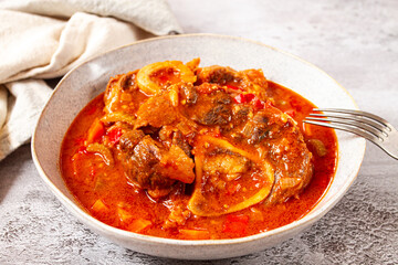 ossobuco, stewed meat knuckle on the bone, with oats and spices, homemade, no people,