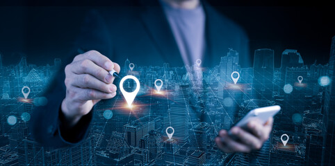 Businessman using mobile phone and stylus for smart city location mapping. Digital location pins and cityscape for modern navigation technology and data connectivity.