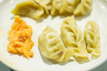 Momo , type of South Asian dumpling; native to Tibet, Nepal, Bhutan and Sikkim. It is similar to Chinese baozi and jiaozi, Mongolian buuz, Japanese gyoza and Korean mandu. Stock photograph.