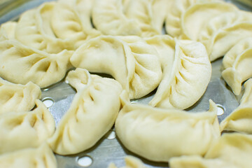 Close up of Momo, type of South Asian dumpling; native to Tibet, Nepal, Bhutan and Sikkim. It is similar to Chinese baozi and jiaozi, Mongolian buuz, Japanese gyoza and Korean mandu. Stock photograph.
