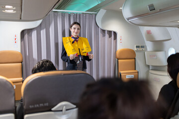 Flight attendant demonstrating safety instructions onboard