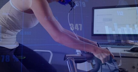 Mid adult female pedaling stationary bike while fitting mask and charts updating for fitness test - Powered by Adobe