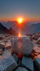 Majestic mountain sunrise landscape with a powerful flare and dramatic rock formation