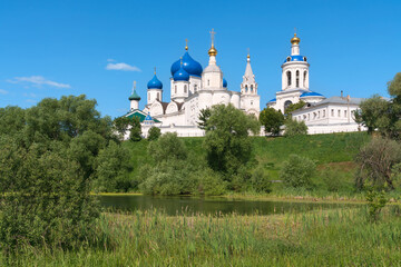 Fototapeta premium Bogolyubsky Monastery of the Nativity of the Virgin is a female Orthodox monastery on the banks of the Monastic Pond on a sunny summer day, Bogolyubovo, Suzdal district, Vladimir region, Russia