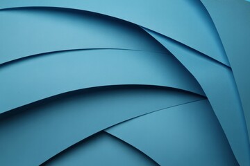 Layers of blue paper create a dynamic texture with curves and waves under soft lighting in an artistic arrangement