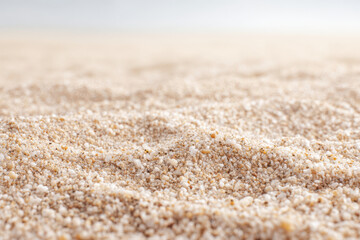 Fototapeta premium closeup view of sandy texture showcasing fine grains and subtle variations in color