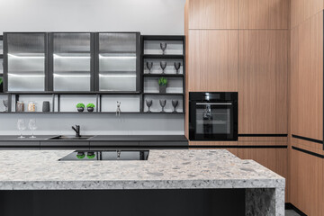 built-in kitchen with upper and lower cabinets. facades are wooden, gray and glass. Built-in...