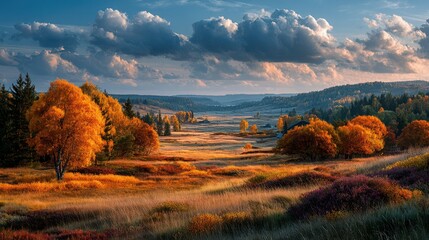 Scenic autumn landscape showcasing vibrant colors and cloud-filled sky during sunset in a serene valley
