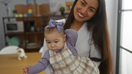 Fototapeta premium Woman holding baby with love in cozy home setting, showing family bonding and happiness, highlighting the joy in an indoor apartment environment.