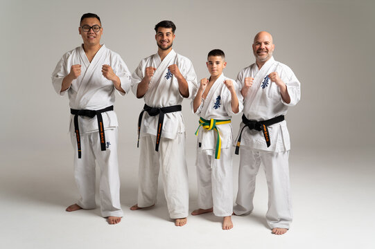 Kyokushinkai karatekas posing in fighting stance on white background