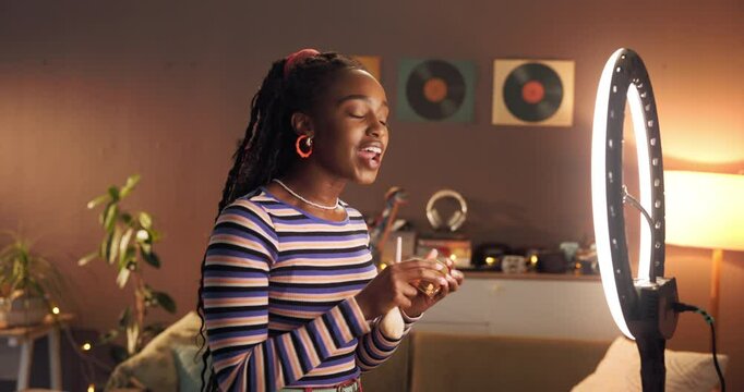 Makeup, influencer and ring light with black woman in home for cosmetics promotion, brand and vlog. Beauty sponsorship, follower engagement and content creator with person and phone for recording