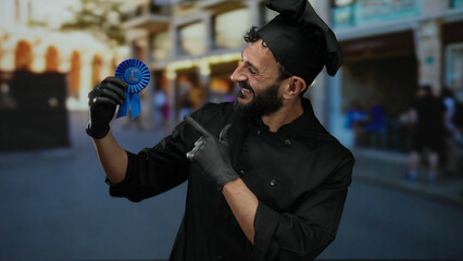 Hispanic man in chef attire proudly displaying award ribbon on a bustling street, symbolizing outdoor culinary success and achievement.
