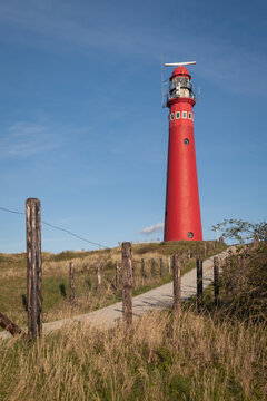 postcard with ed lighthouse and path on the coast ot the dutch island of schiermonnikoog