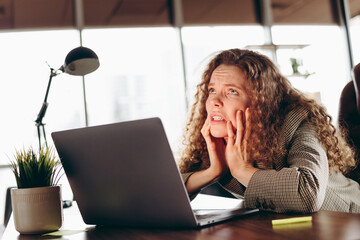 Sad Young Female Professional Expressing Workplace Stress in a Modern Office Setting