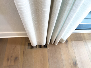 Wide Neutral Curtains Over Vent on Hardwood Floor